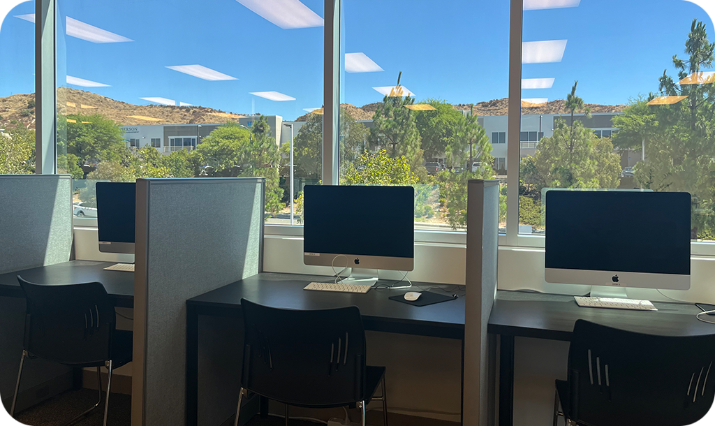 Desks with computers by a window