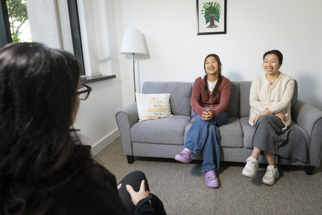 teen and parent in an in-person therapy session